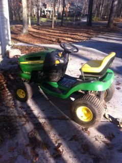 John Deere LA105 Riding Mower with Mower Deck Parts and Damaged Mower Deck